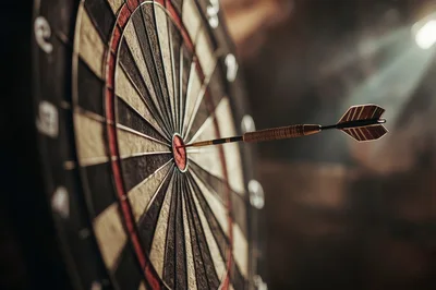 Dart Hitting The Bullseye On A Dartboard