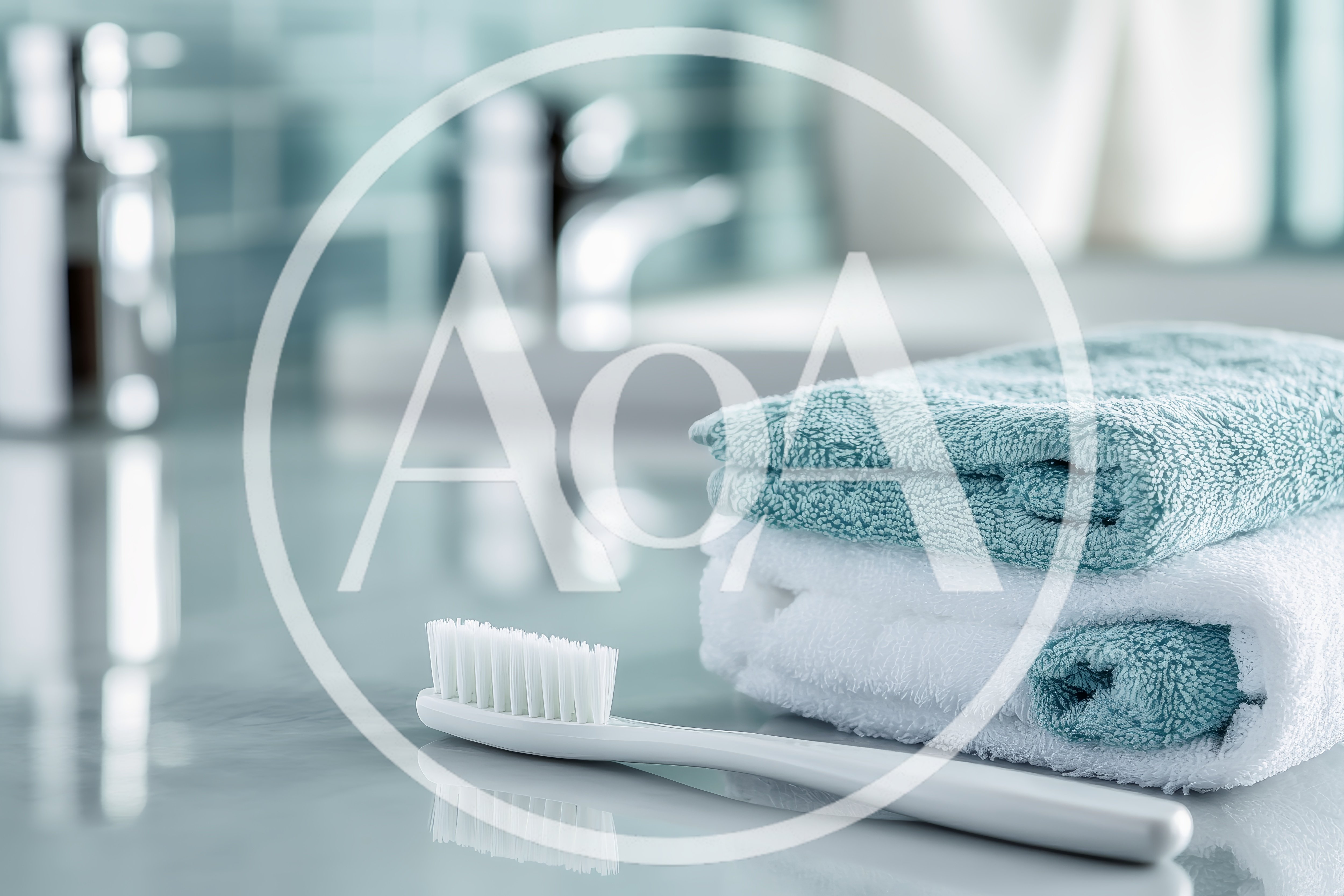 White Toothbrush And Stacked Towels On Bathroom Counter
