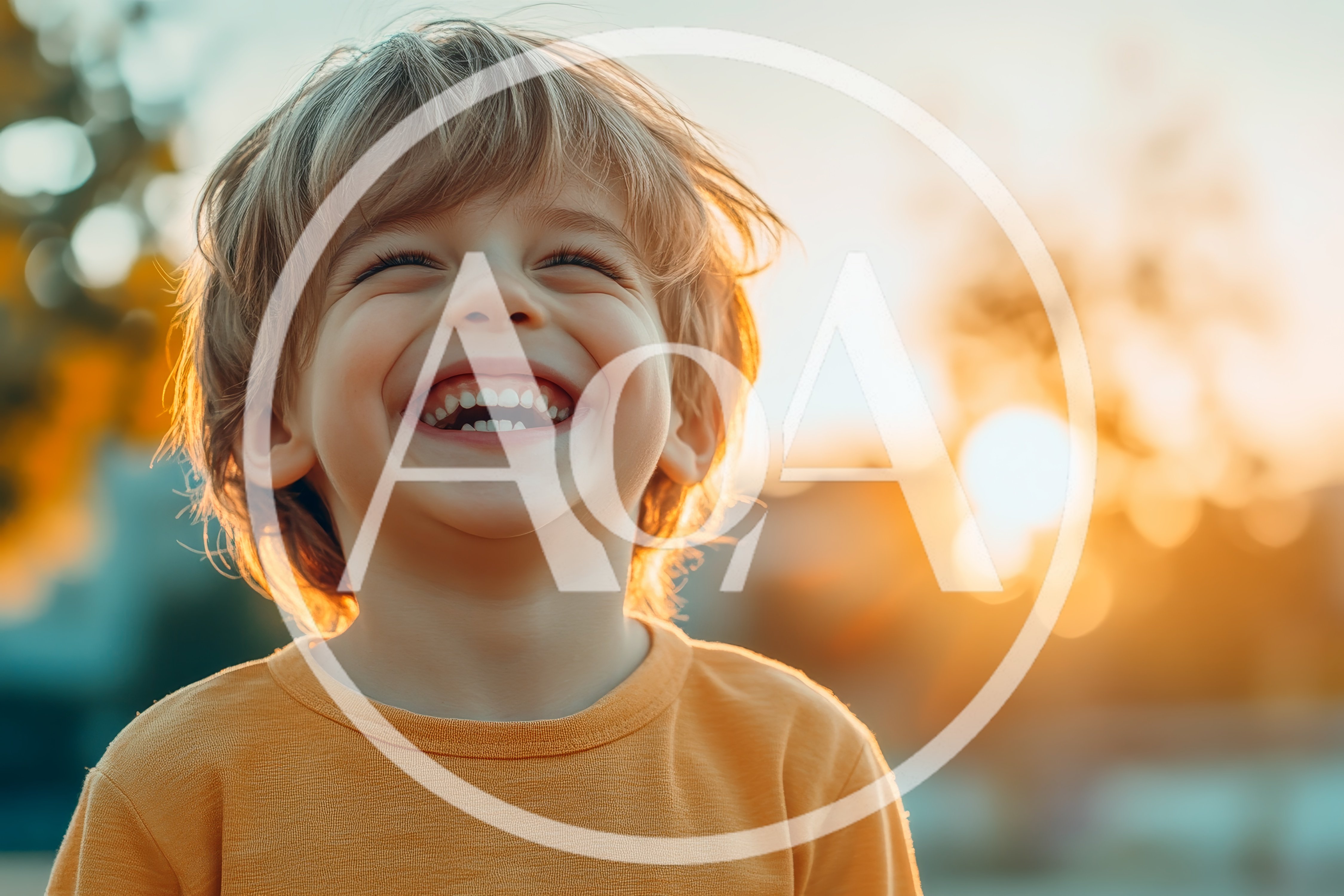 Happy Young Boy Laughing Outdoors During Golden Hour