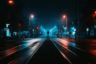 Lone Pedestrian Walking Along Empty City Tram Tracks