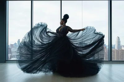 Elegant Woman In Black Gown Dancing In High Rise