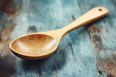 Wooden Spoon Resting On A Rustic Blue Wooden Surface