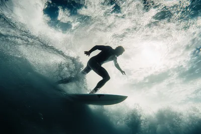 Surfer Riding A Wave Underwater View