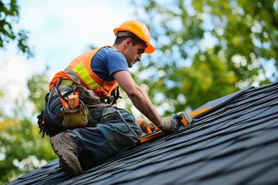 Roofer Installing Asphalt Shingles On A Residential Roof