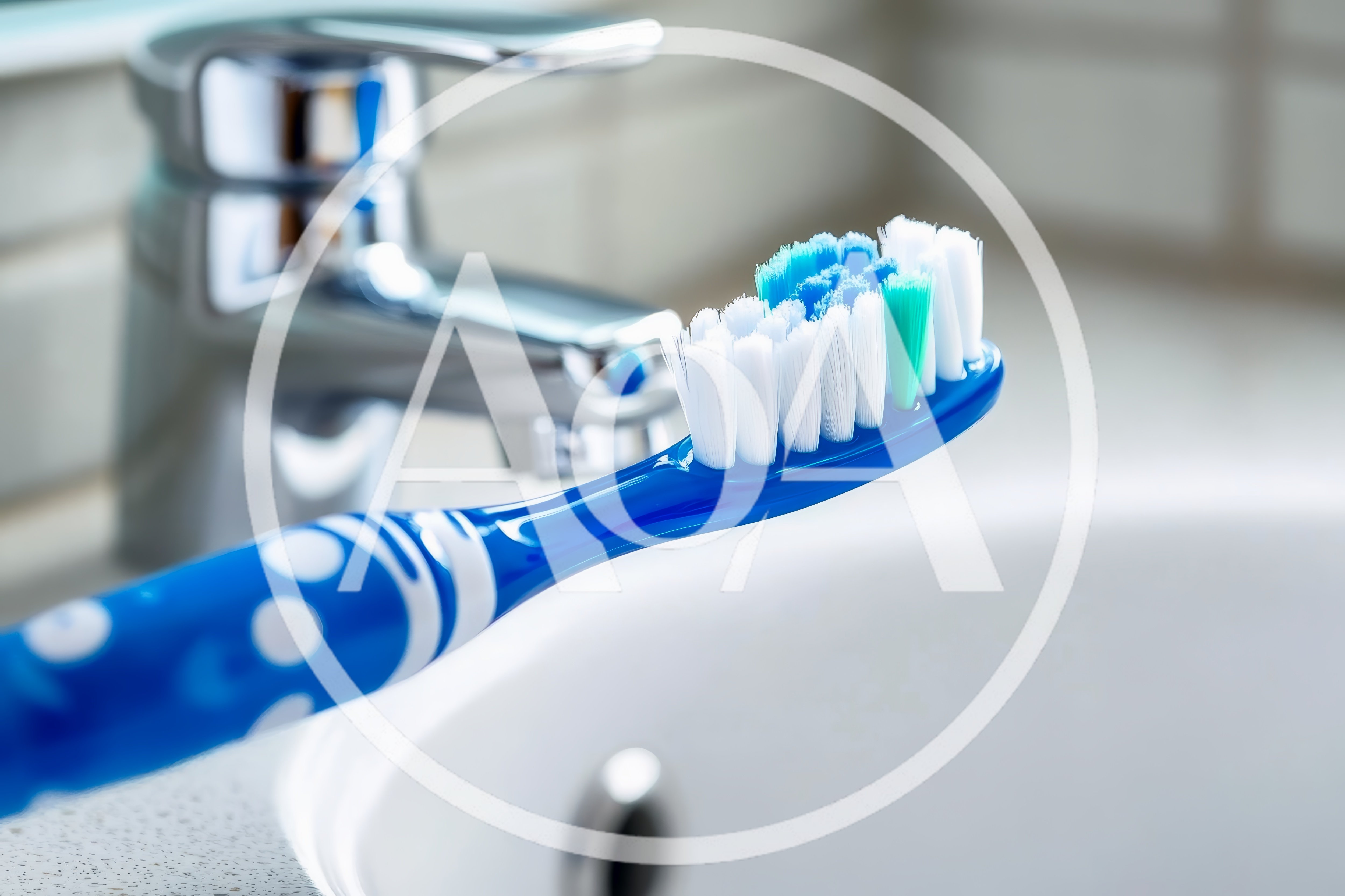 Blue Toothbrush Resting Near Bathroom Sink Faucet