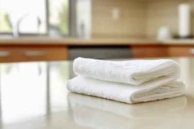 Folded White Kitchen Towel on Countertop