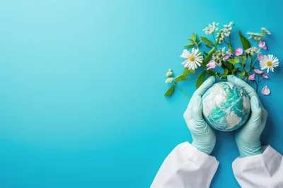 Scientist Holding Earth Globe With Flowers