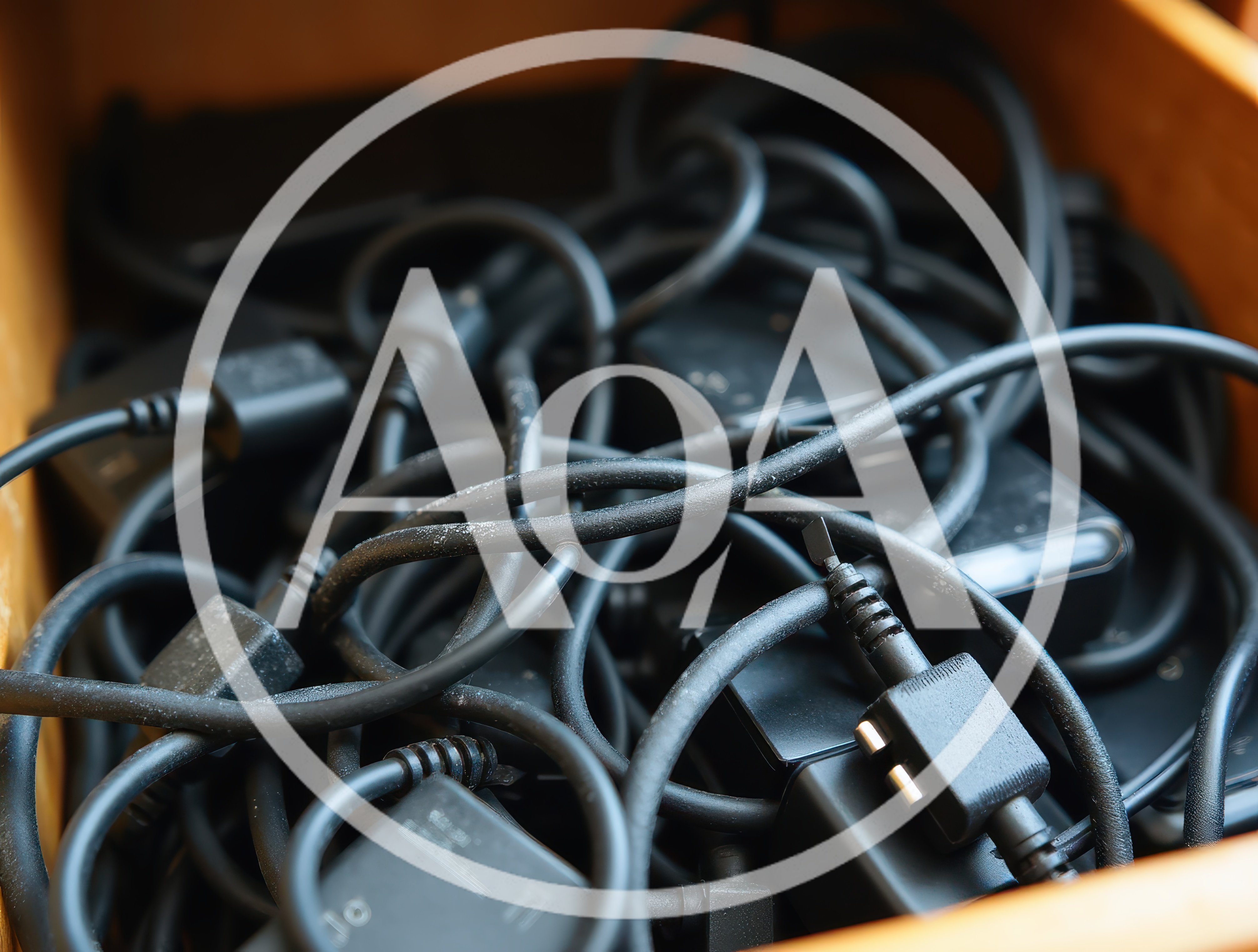 Messy Drawer Filled With Tangled Black Power Cables