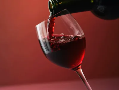 Red Wine Being Poured Into A Glass