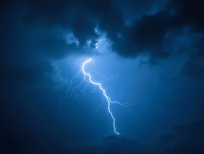 Bright Lightning Bolt Striking Through Dark Storm Clouds