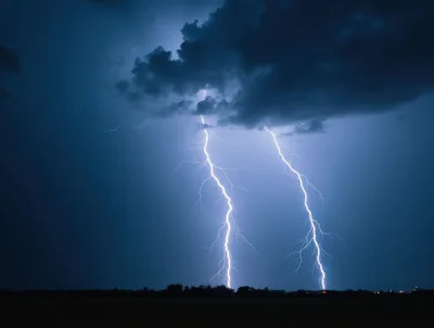 Two Powerful Lightning Bolts Striking During A Night Storm