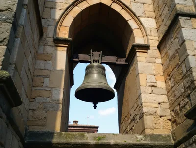 Large Bronze Church Bell Hanging In Stone Archway