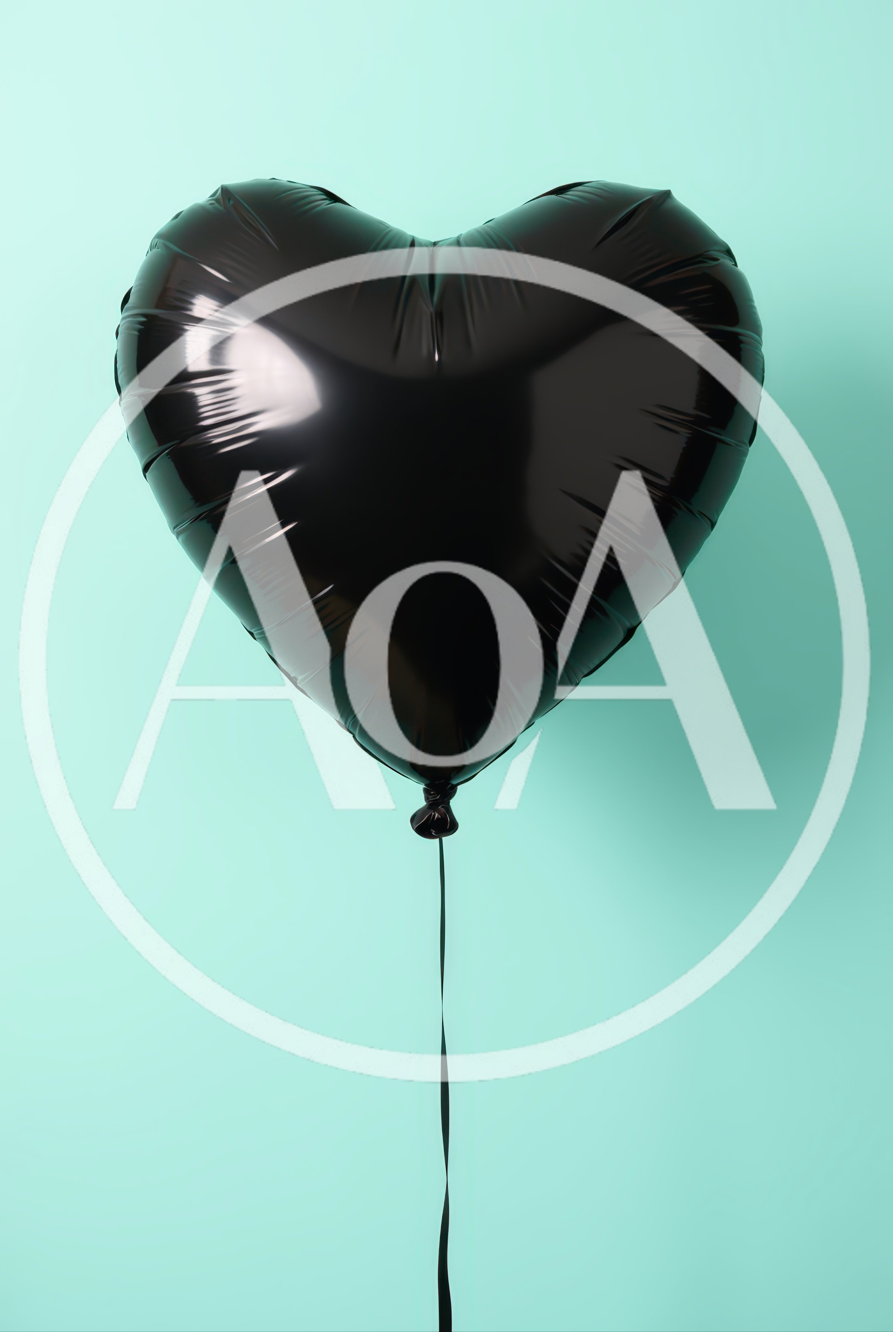 Black Heart Shaped Balloon Against Pastel Green Background