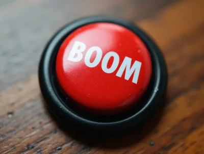 Red Boom Button On A Wooden Surface