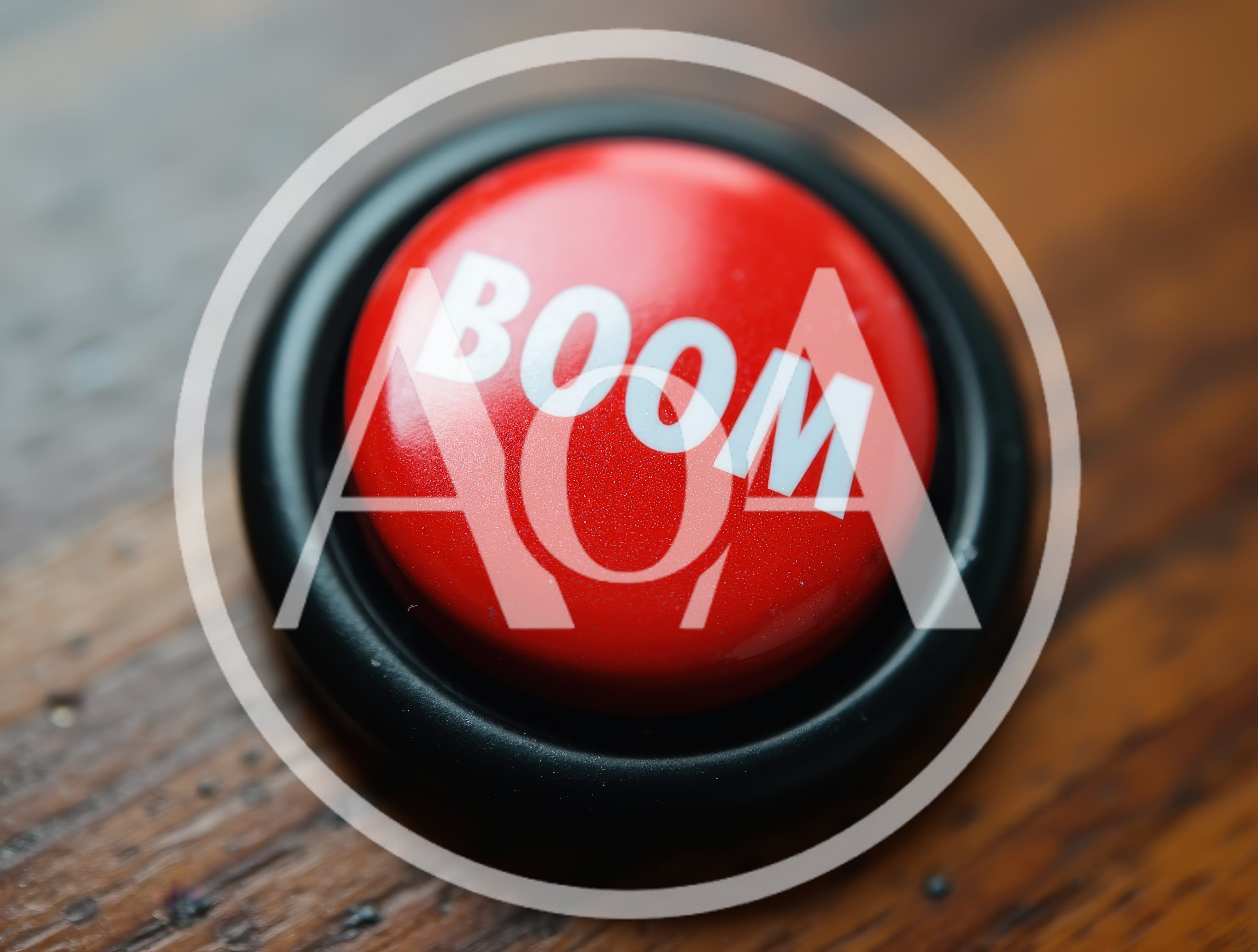 Red Boom Button On A Wooden Surface