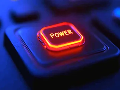 Glowing Red Power Button On A Dark Keyboard
