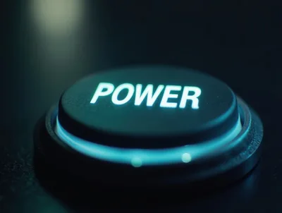 Glowing Power Button On A Dark Surface