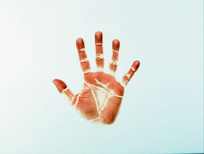 Red Handprint On A Light Blue Background