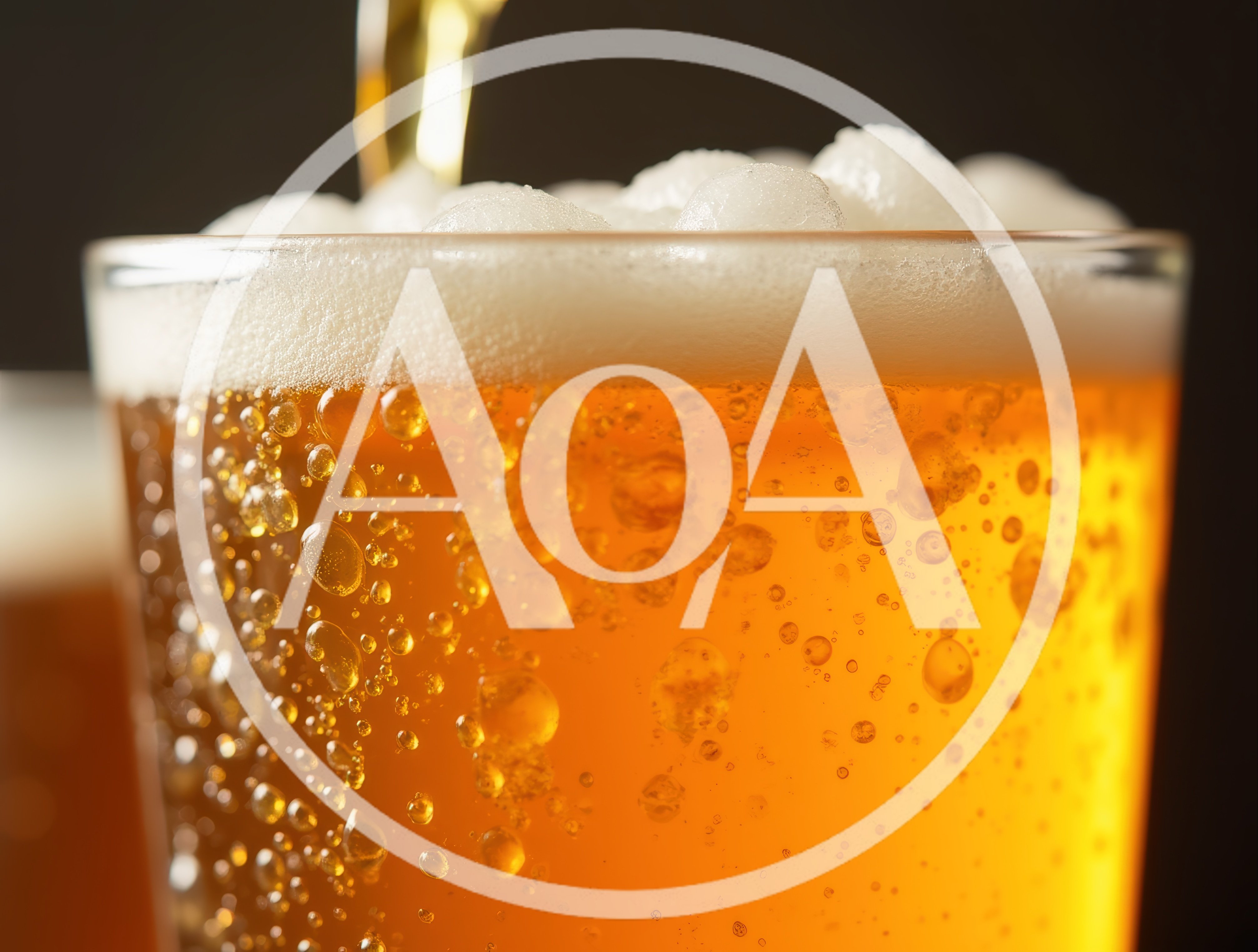 Golden Beer Pouring Into A Glass With Bubbles
