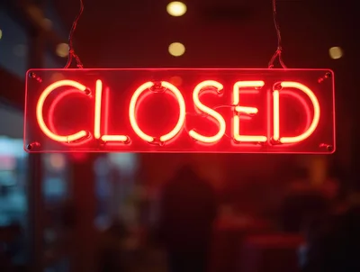 Red Neon Closed Sign Hanging In A Window
