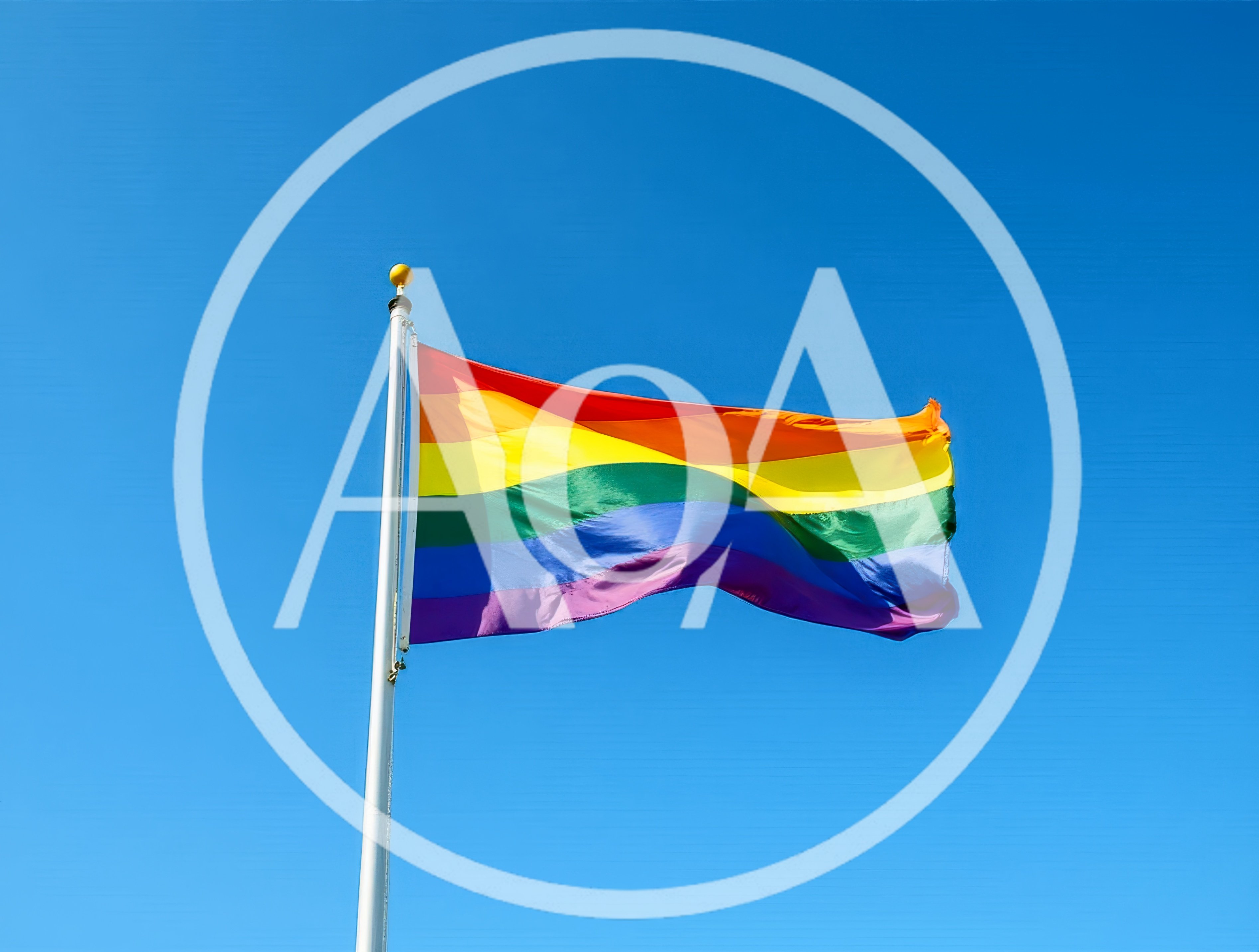 Rainbow Pride Flag Waving Against Clear Blue Sky