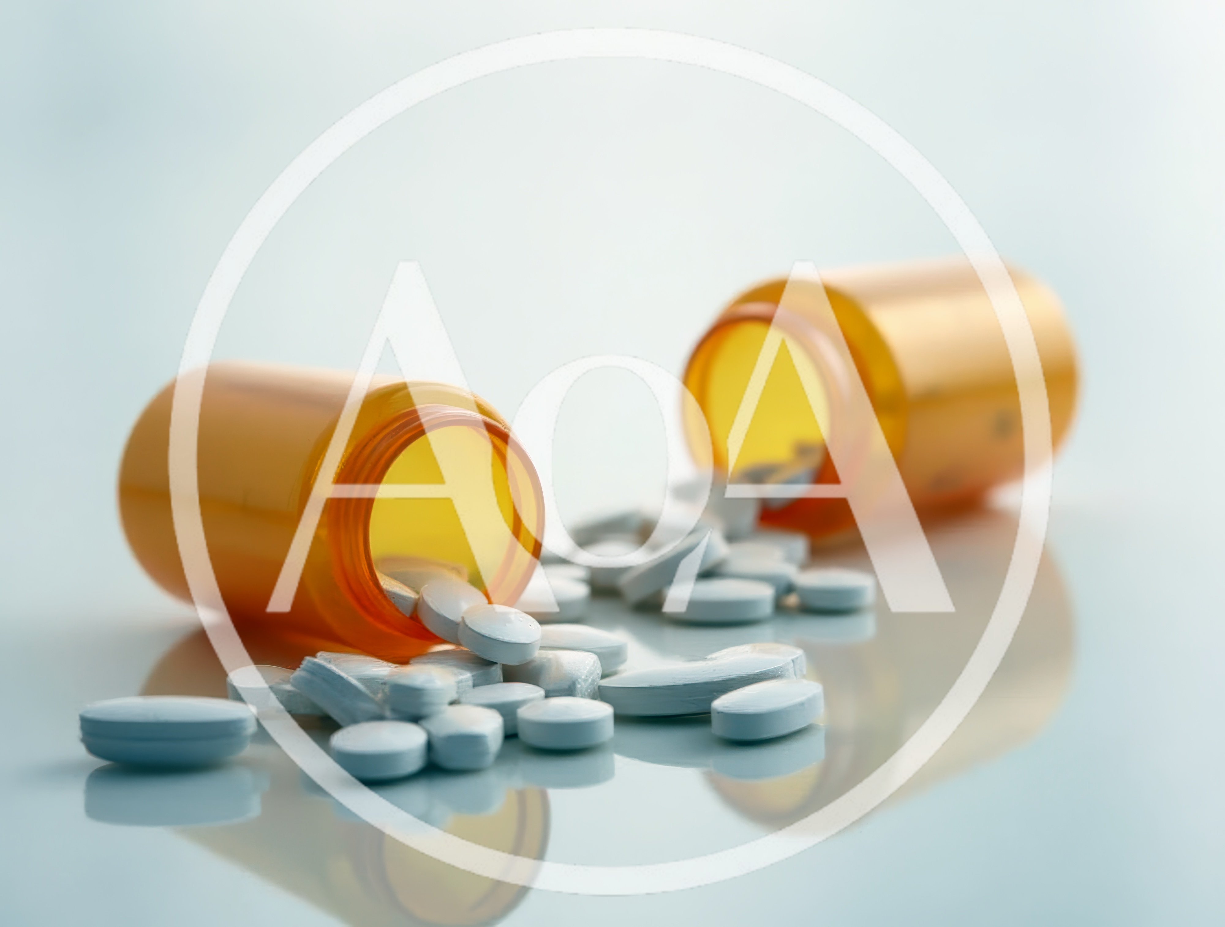 Two Spilled Orange Prescription Pill Bottles With Tablets