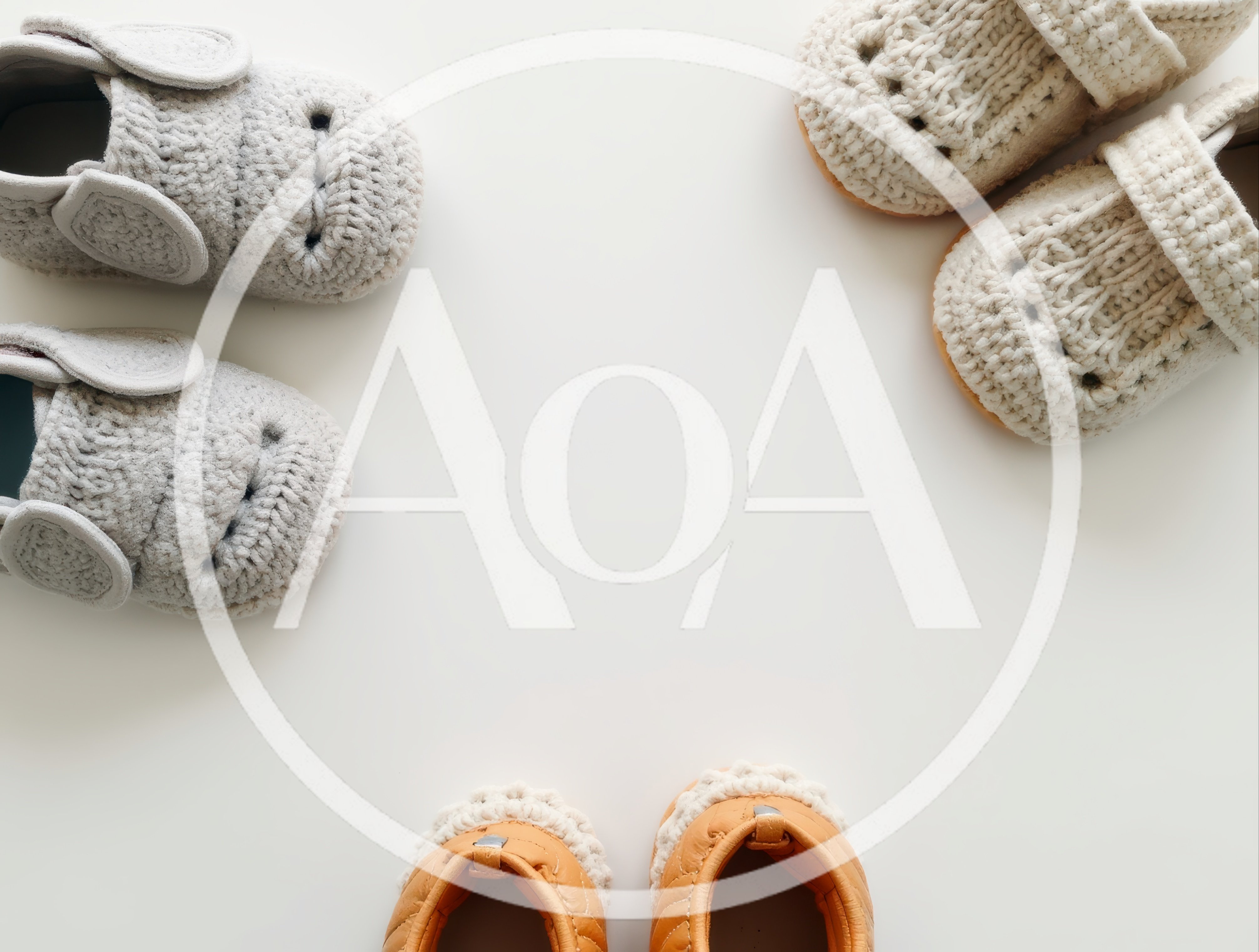 Three Pairs Of Baby Shoes On White Background