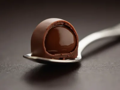 Chocolate Truffle Resting On A Silver Spoon