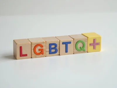 LGBTQ Plus Wooden Blocks on White Background