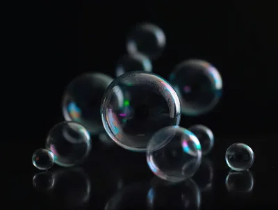 Floating Soap Bubbles Against A Dark Background