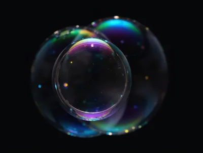 Iridescent Soap Bubbles Floating Against Black Background