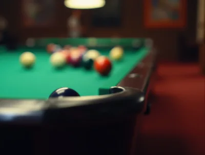 Billiard Table With Colorful Balls In A Dimly Lit Room