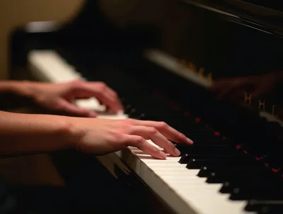 Close Up Of Hands Playing A Grand Piano