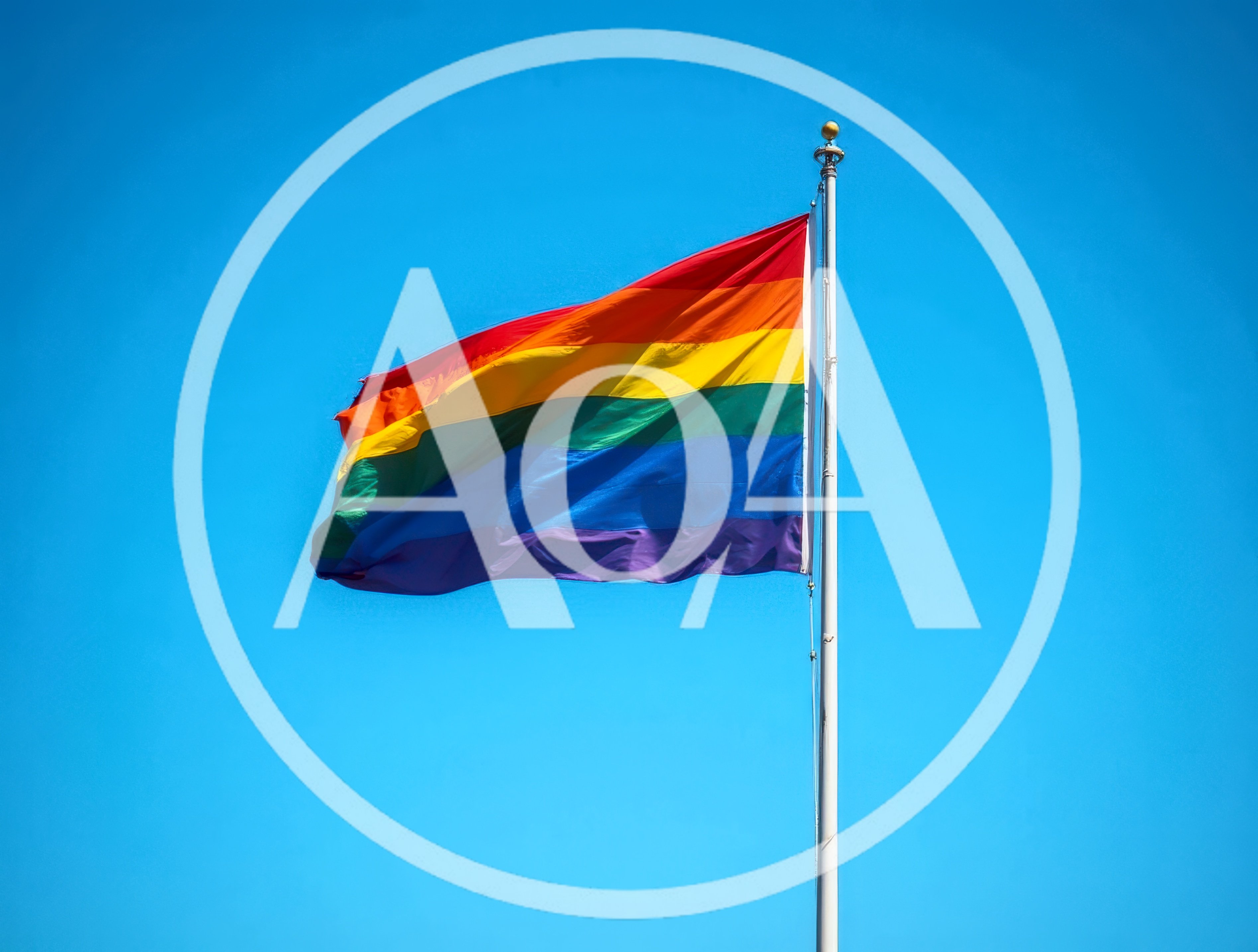 Rainbow Pride Flag Waving Against Clear Blue Sky