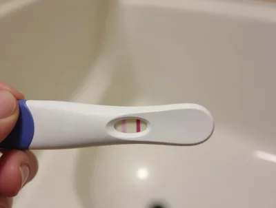 Positive Pregnancy Test Held In Hand