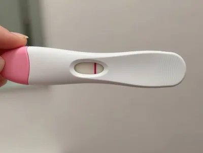 Hand Holding A Single Line Pregnancy Test