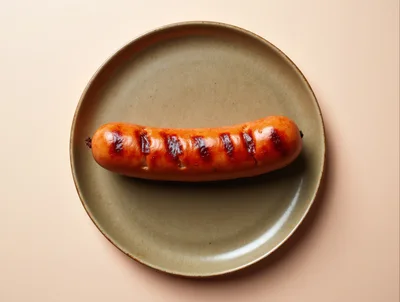 Grilled Sausage Served On A Ceramic Plate