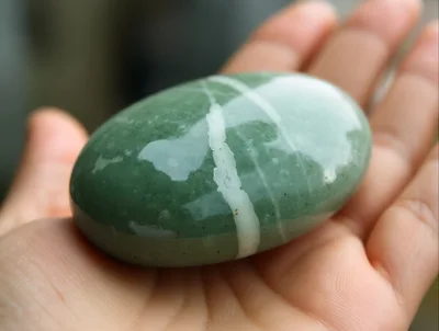 Polished Green Aventurine Stone Held In Palm
