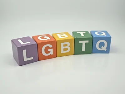 LGBTQ Letter Blocks Arranged On A White Surface