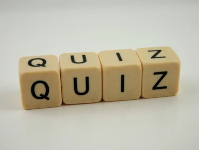 Four Beige Dice Spelling The Word Quiz