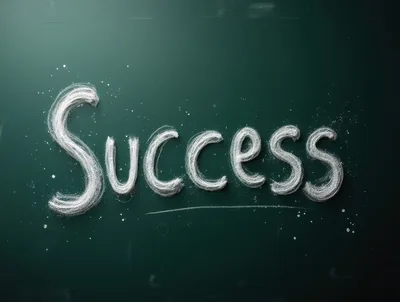 Success Written In White Chalk On Green Blackboard