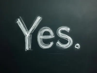 Yes Written In White Chalk On A Blackboard