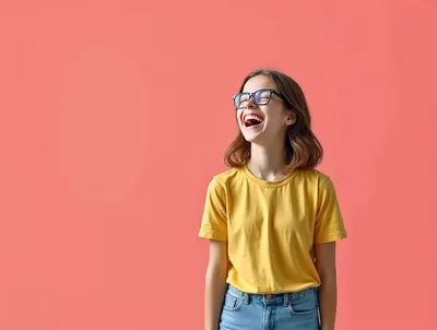 Young Woman Laughing Joyfully Against A Pink Background