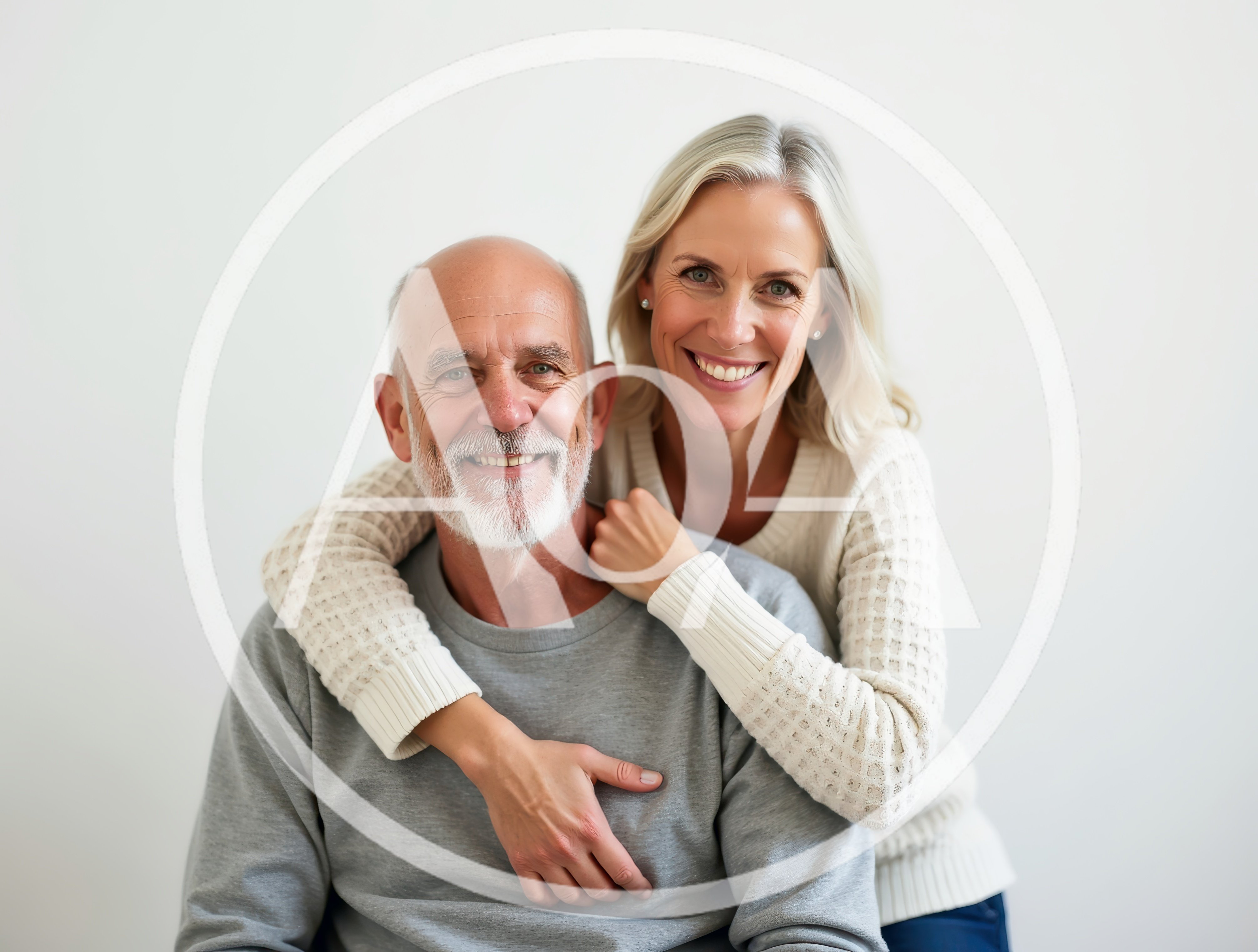 Happy Senior Couple Embracing Against White Background