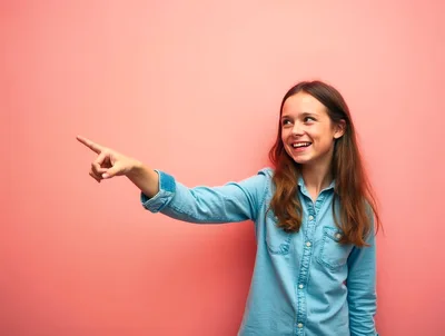 Young Girl Pointing To The Side Against Pink Background