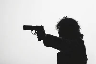 Silhouette Of A Person Holding A Handgun