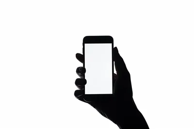 Silhouette Of A Hand Holding A Smartphone