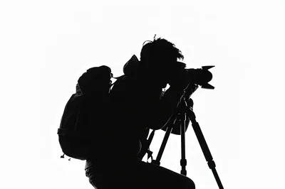 Silhouette Of A Photographer Using A Tripod
