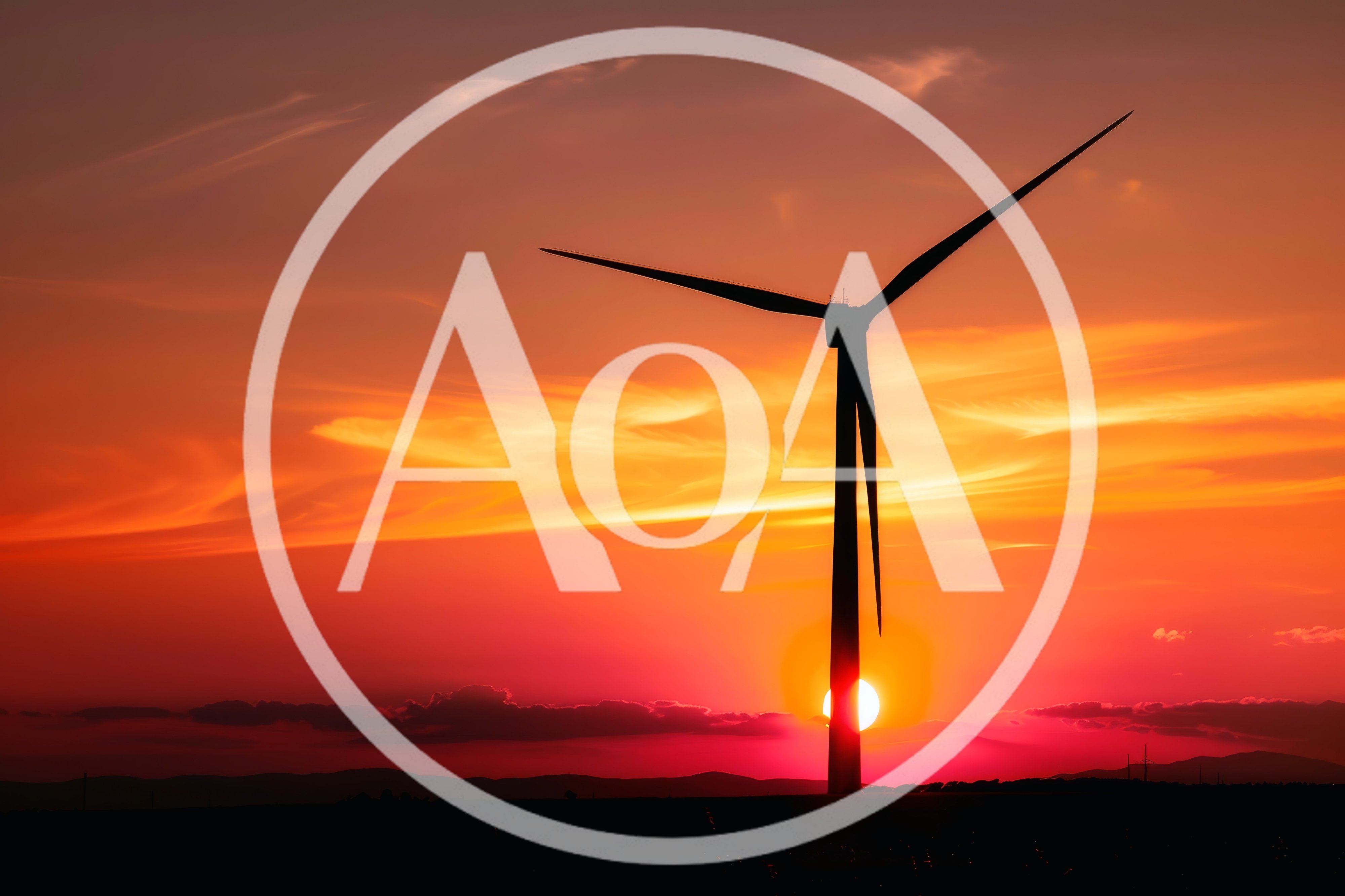 Wind Turbine Silhouette Against A Vibrant Sunset
