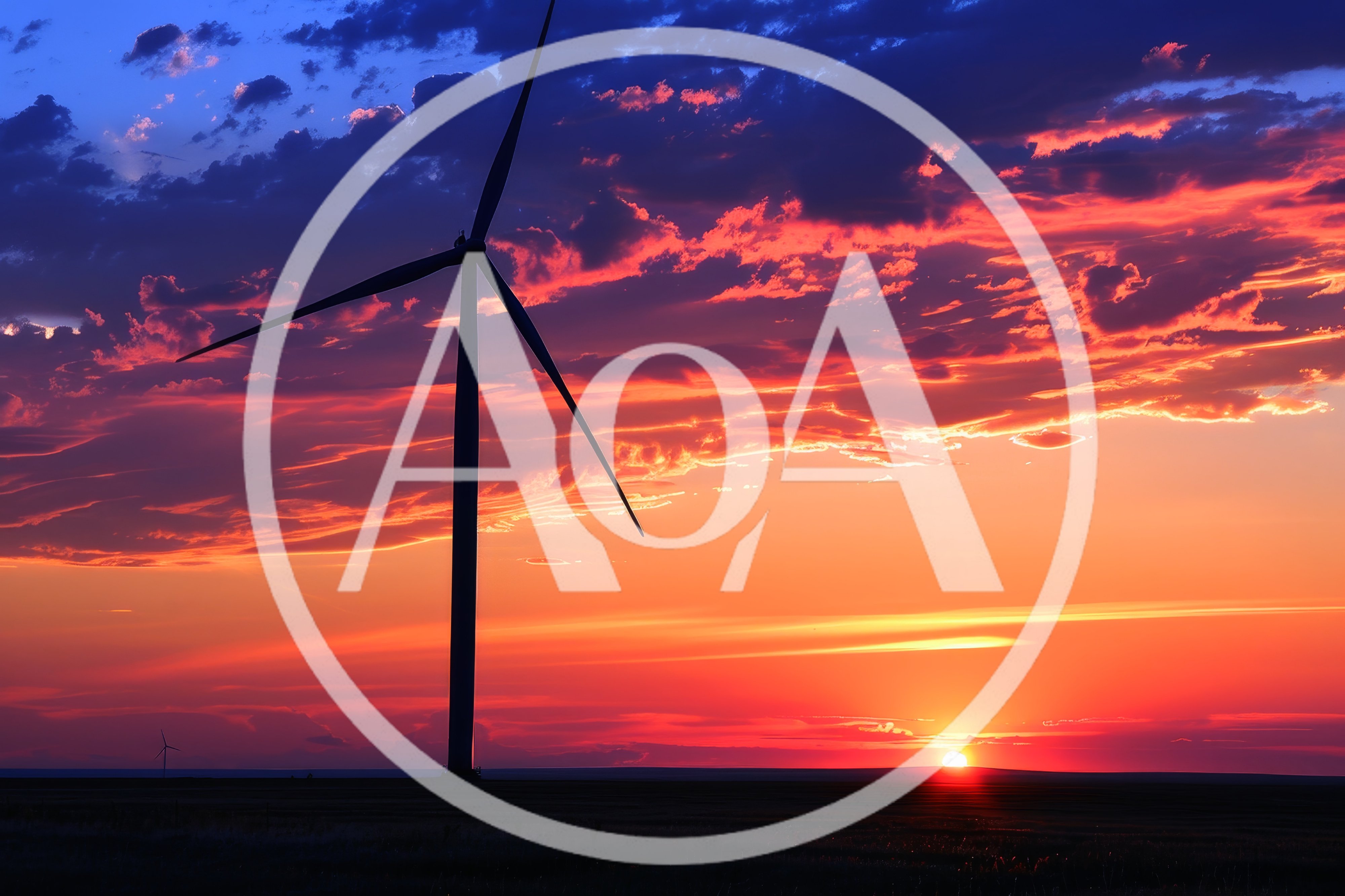 Wind Turbine Silhouette Against A Vibrant Sunset